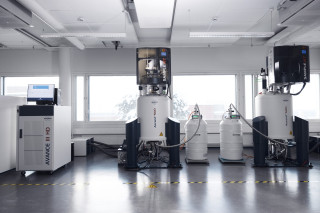 Nuclear magnetic resonance spectroscopy instruments used for large-scale biomarker analysis in a laboratory, photograph.