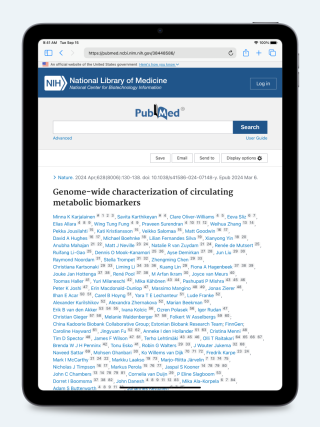 iPad displaying the publication “Genome-Wide Characterization of Circulating Metabolic Biomarkers”, screenshot.