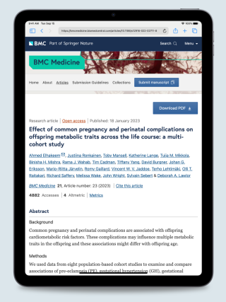 iPad displaying the publication “Effect of Common Pregnancy and Perinatal Complications on Offspring Metabolic Traits Across the Life Course: A Multi-Cohort Study”, screenshot.